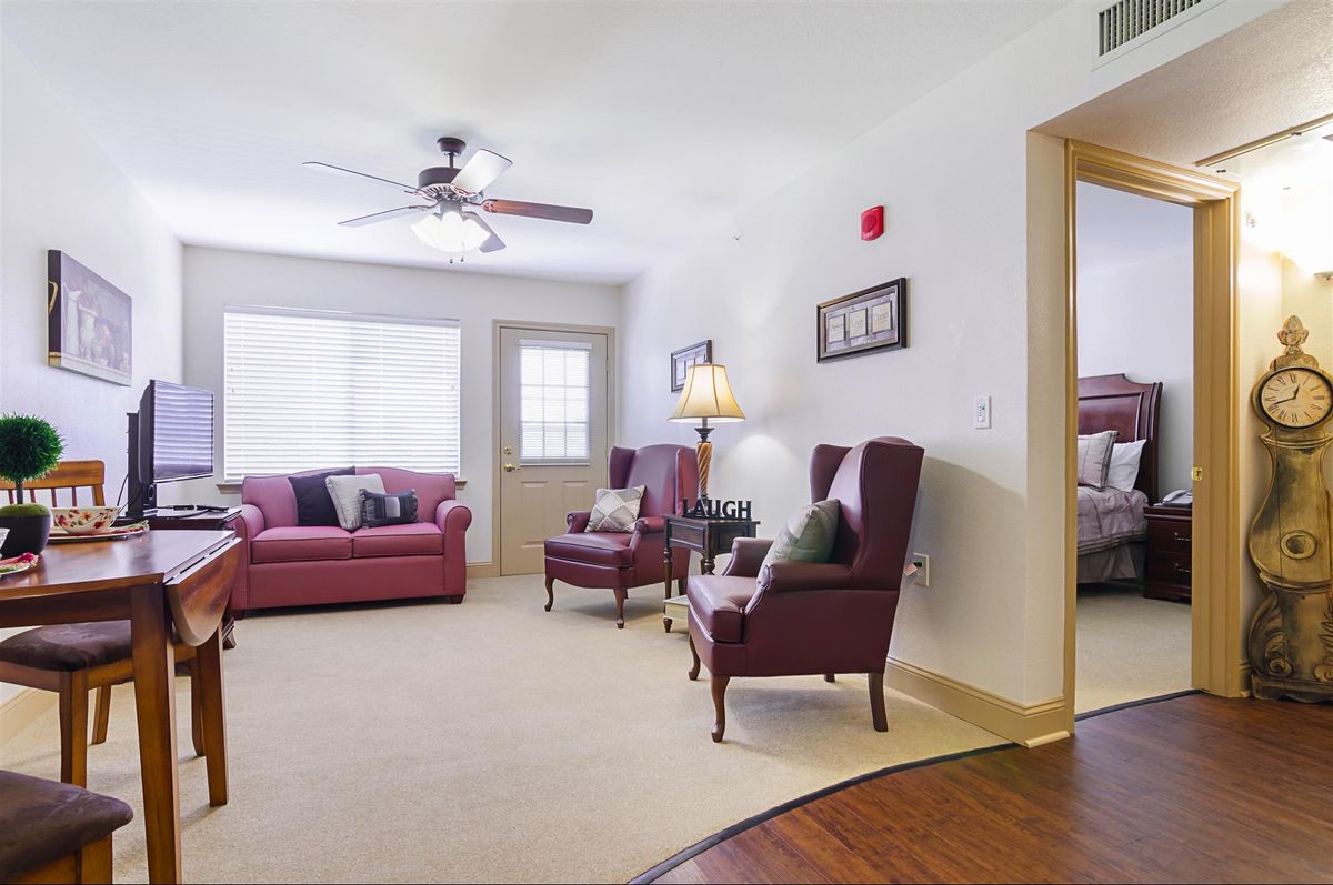 A cozy living room with comfortable seating and warm lighting.