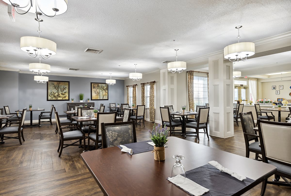 Elegant dining area with arranged tables and modern lighting.