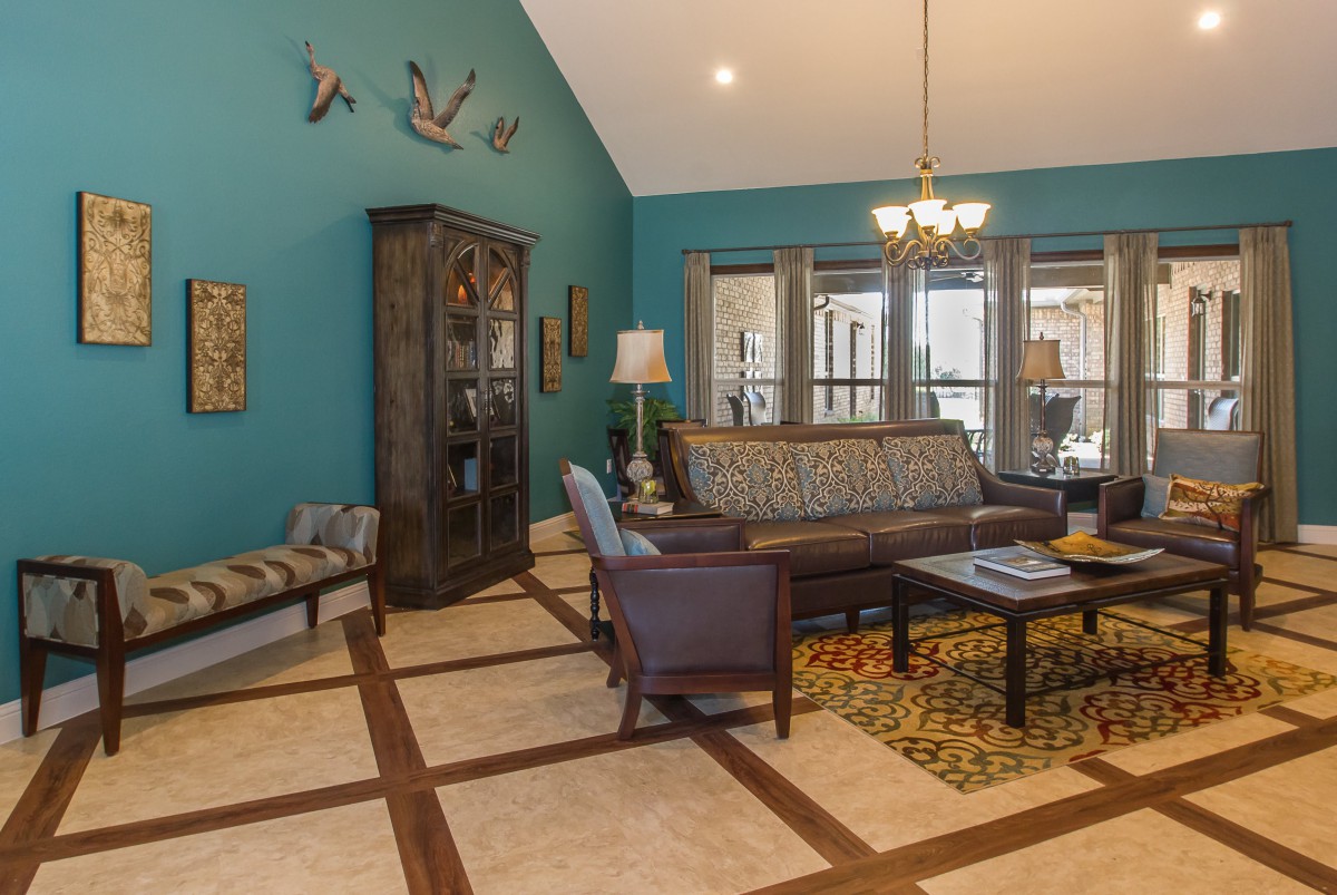 A cozy living room with a sofa, armchairs, and decorative accents.