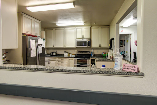 A view of a modern kitchen showcasing various appliances and ample storage.
