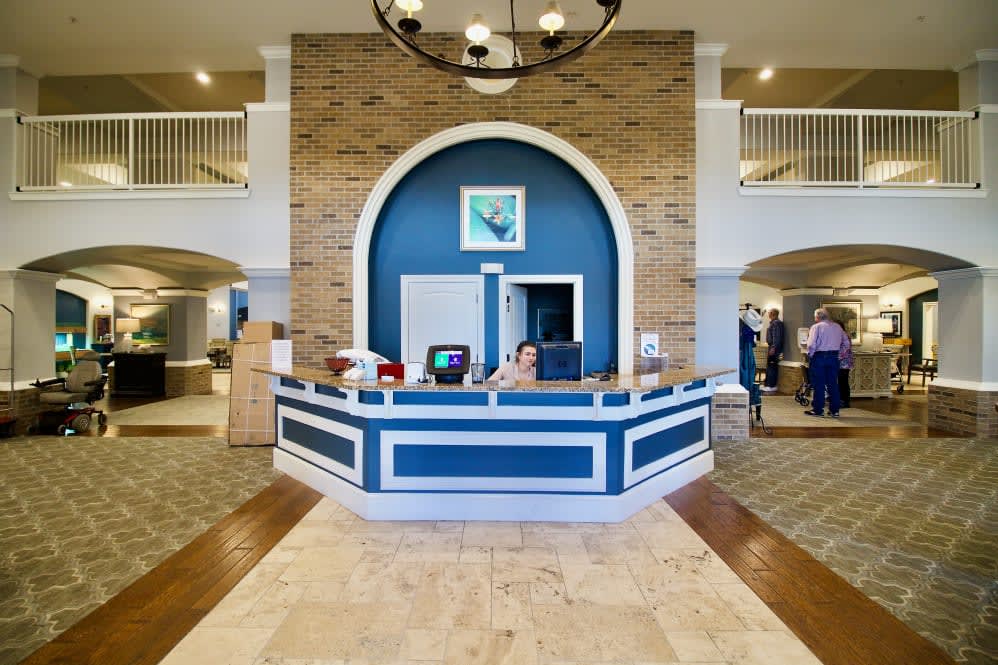 A modern hotel lobby with a stylish reception desk and elegant decor.