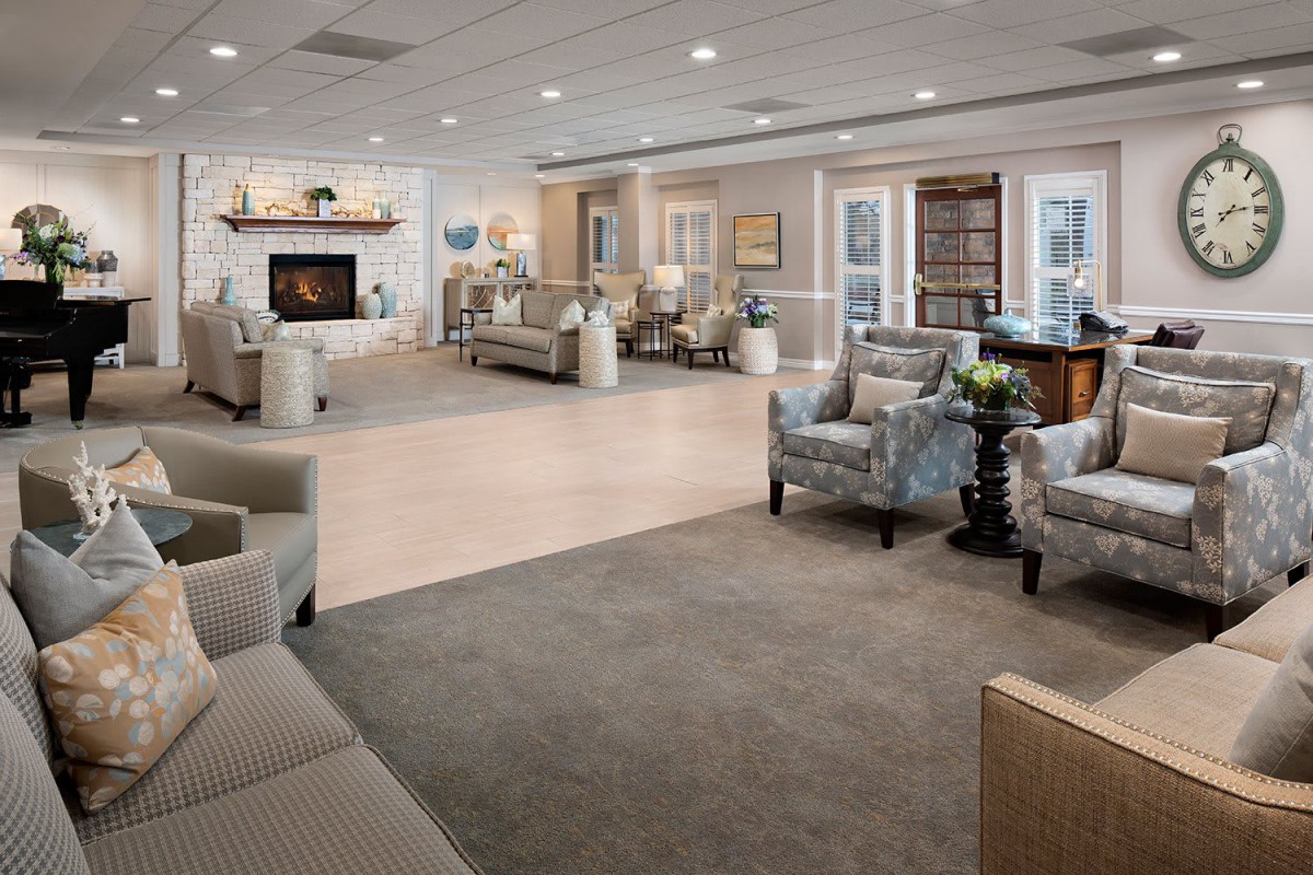A modern and spacious living room with comfortable seating and a fireplace.