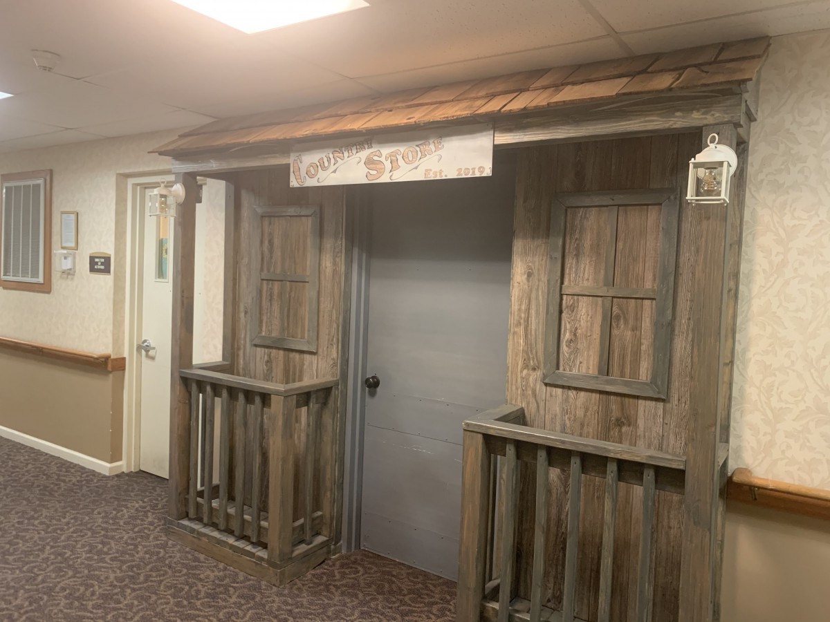 Rustic wooden facade with a central doorway and shuttered windows, evoking a themed decor.
