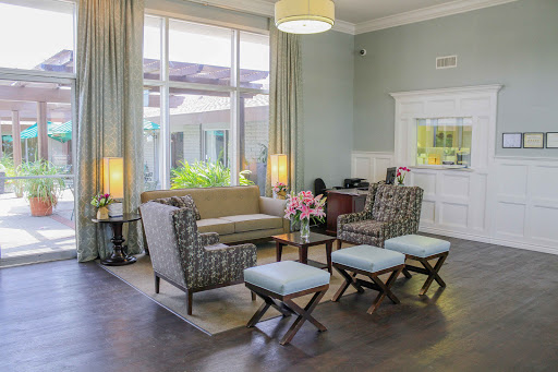 A cozy and modern lounge area with comfortable seating and ample natural light.