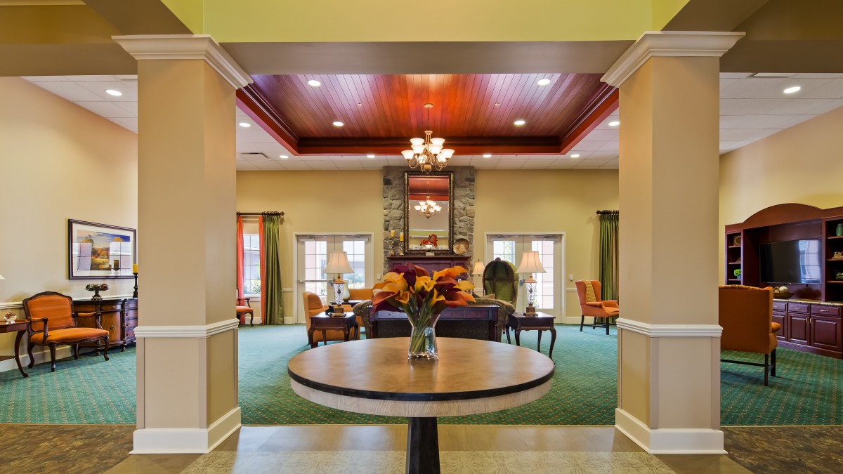 A well-decorated lobby with a table centerpiece and elegant lighting.