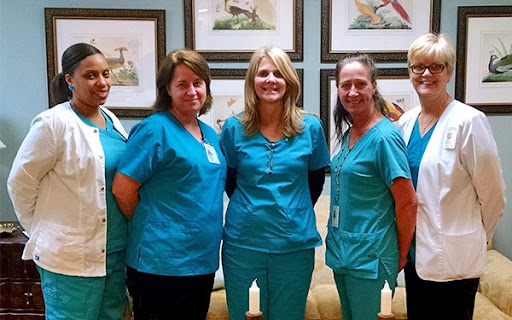 A group of dedicated healthcare professionals posing together in their scrubs.