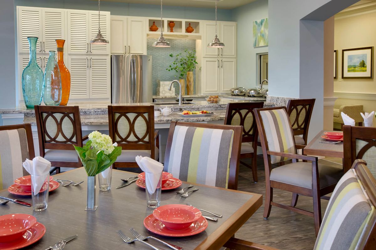 A modern dining area with a well-decorated table, adjacent to a stylish kitchen.