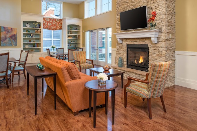 A cozy and contemporary living room with a fireplace, television, and stylish furniture.