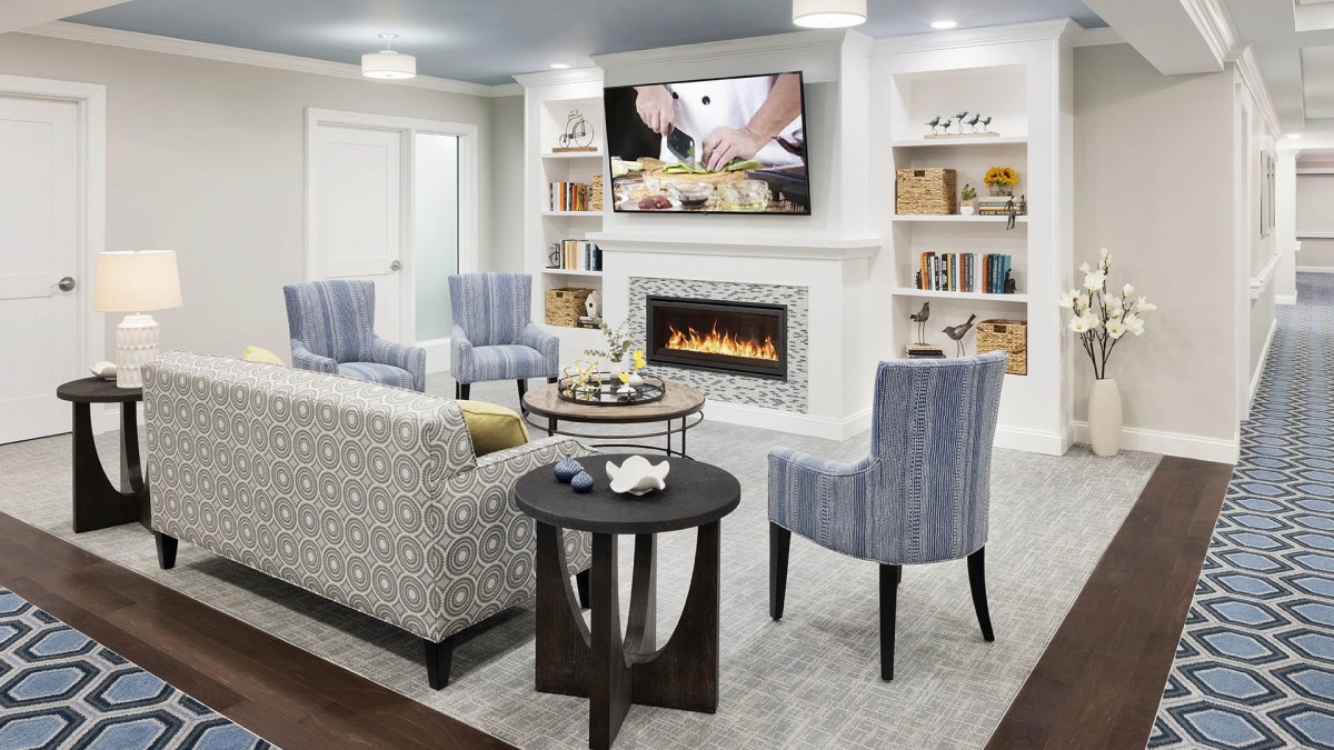 A modern living room with comfortable seating and a cozy fireplace.
