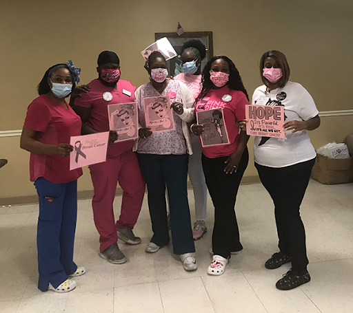 Healthcare professionals gathering to promote breast cancer awareness.