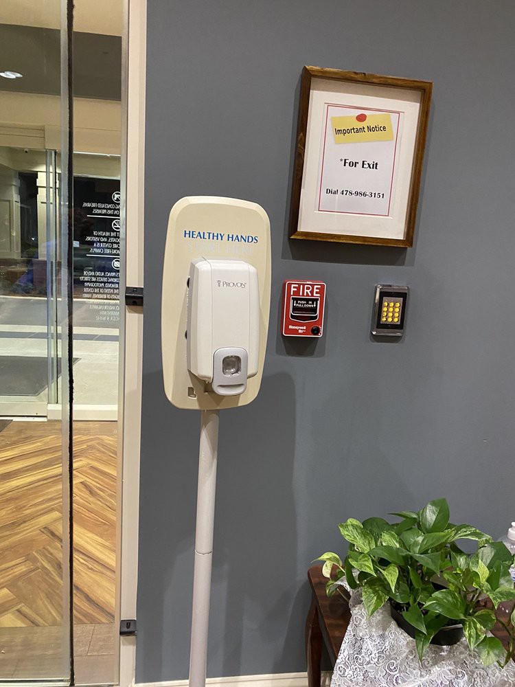 Wall-mounted hand sanitizer dispenser in an office setting.
