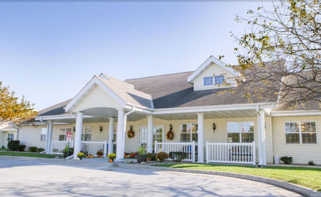A charming suburban house with a large porch and well-maintained exterior.