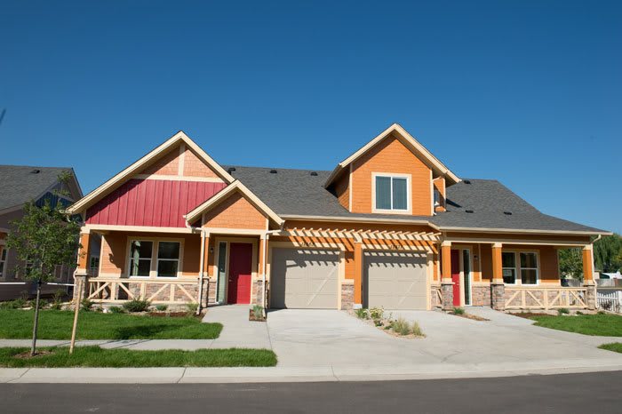 A modern duplex with a vibrant exterior located in a suburban neighborhood.