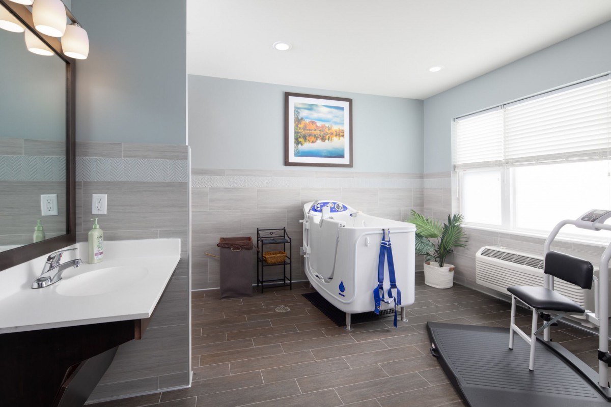 A modern bathroom with a spacious bathtub and elegant decor.