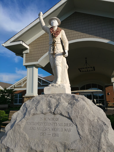 A military statue standing proudly on a rock base, symbolizing honor and service.