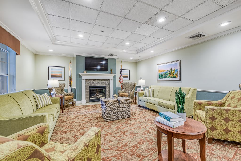 A cozy living room with comfortable seating and a fireplace.