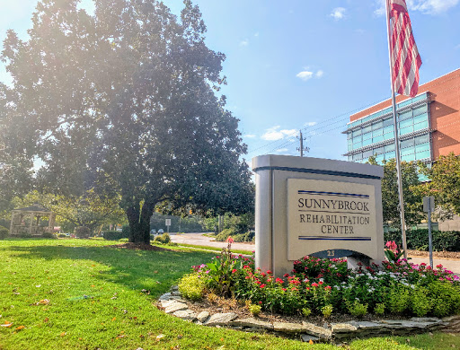 A welcoming view of the Sunstone Physical Therapy center, surrounded by greenery and bright skies.