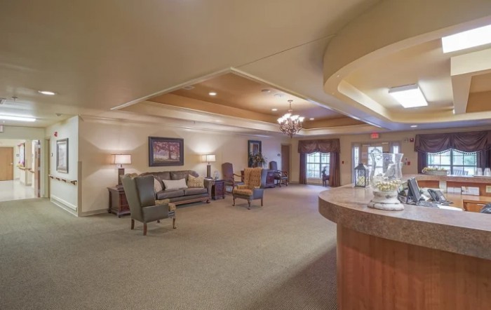 A spacious lobby with elegant furniture and a chandelier.
