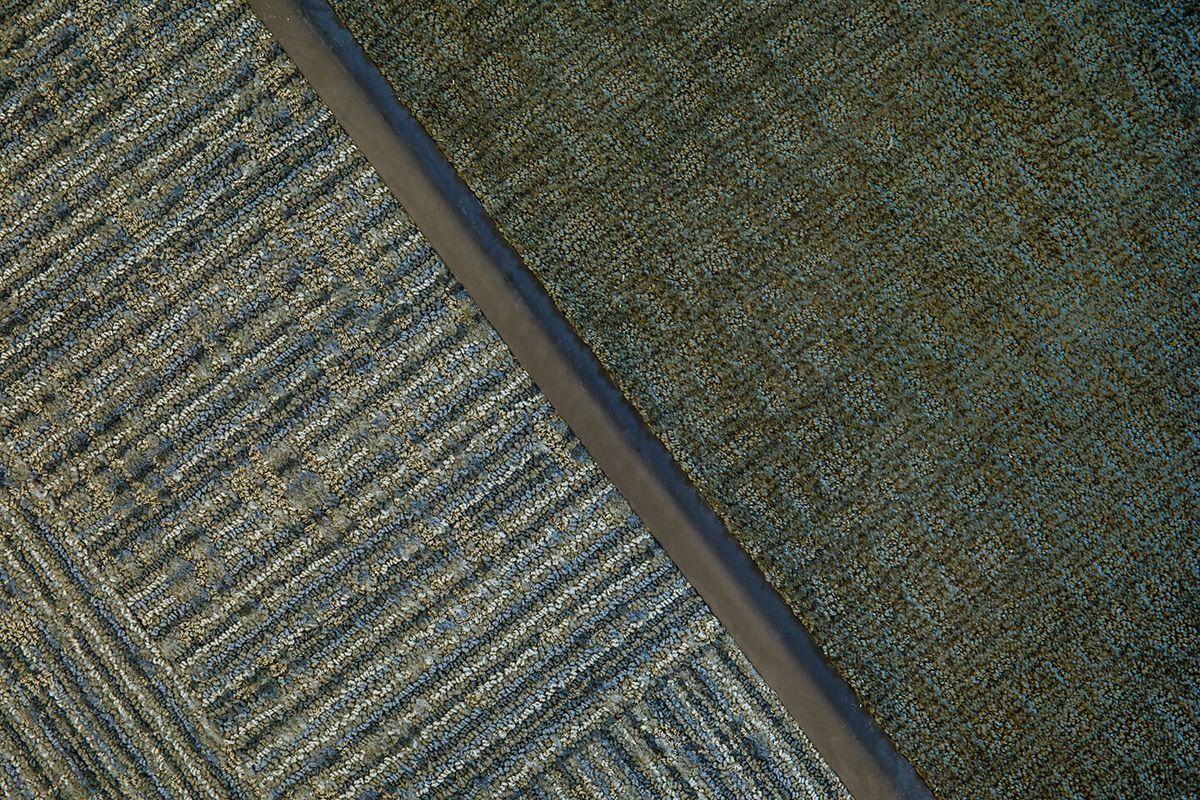 Aerial view of agricultural fields showcasing distinct patterns and textures.