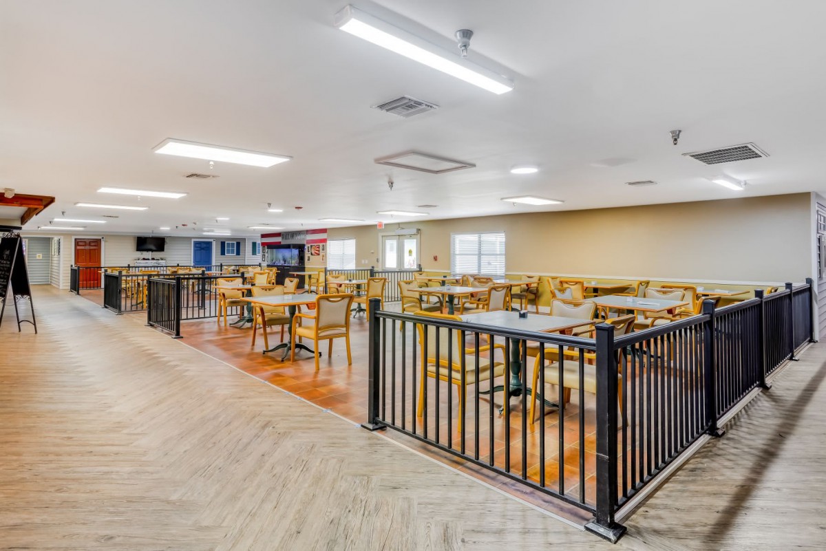 A spacious and well-lit dining area with multiple tables and chairs.