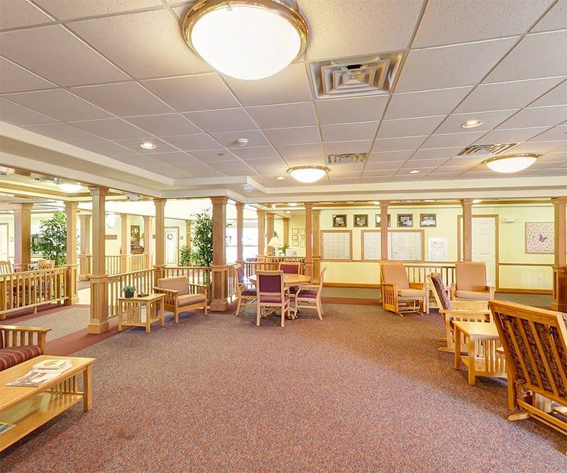 A spacious waiting area with seating and warm lighting.