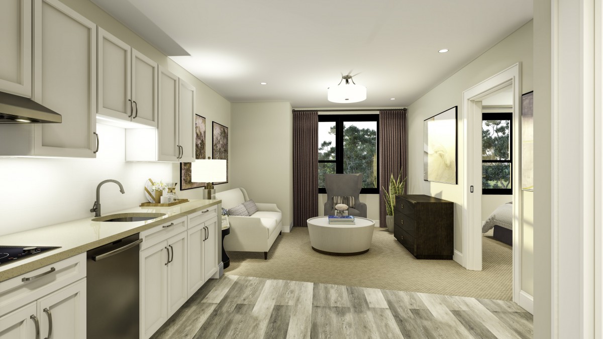 A modern living room with neutral decor and a connected kitchen area.