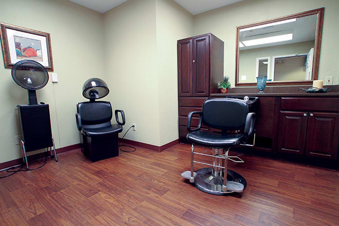 A tidy salon interior with styling chairs and a mirror.