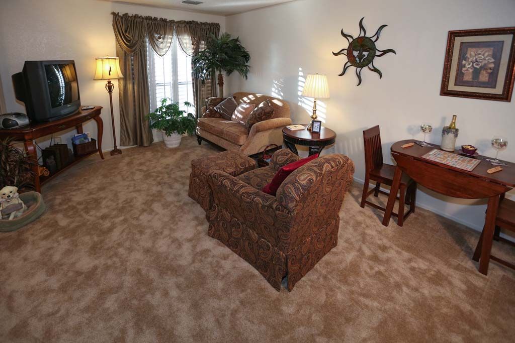 A cozy living room with comfortable seating and warm lighting.