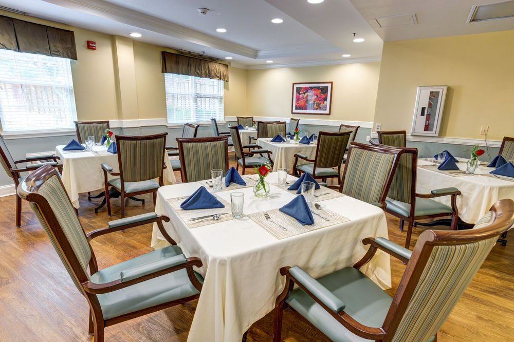 An elegantly set dining room with neatly arranged tables and chairs, ready for guests.