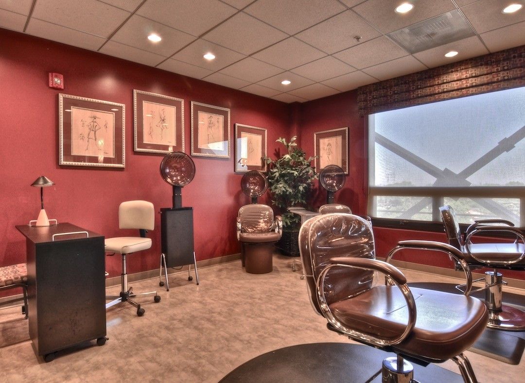 Stylish office interior with chairs, a desk, and artwork on the walls.