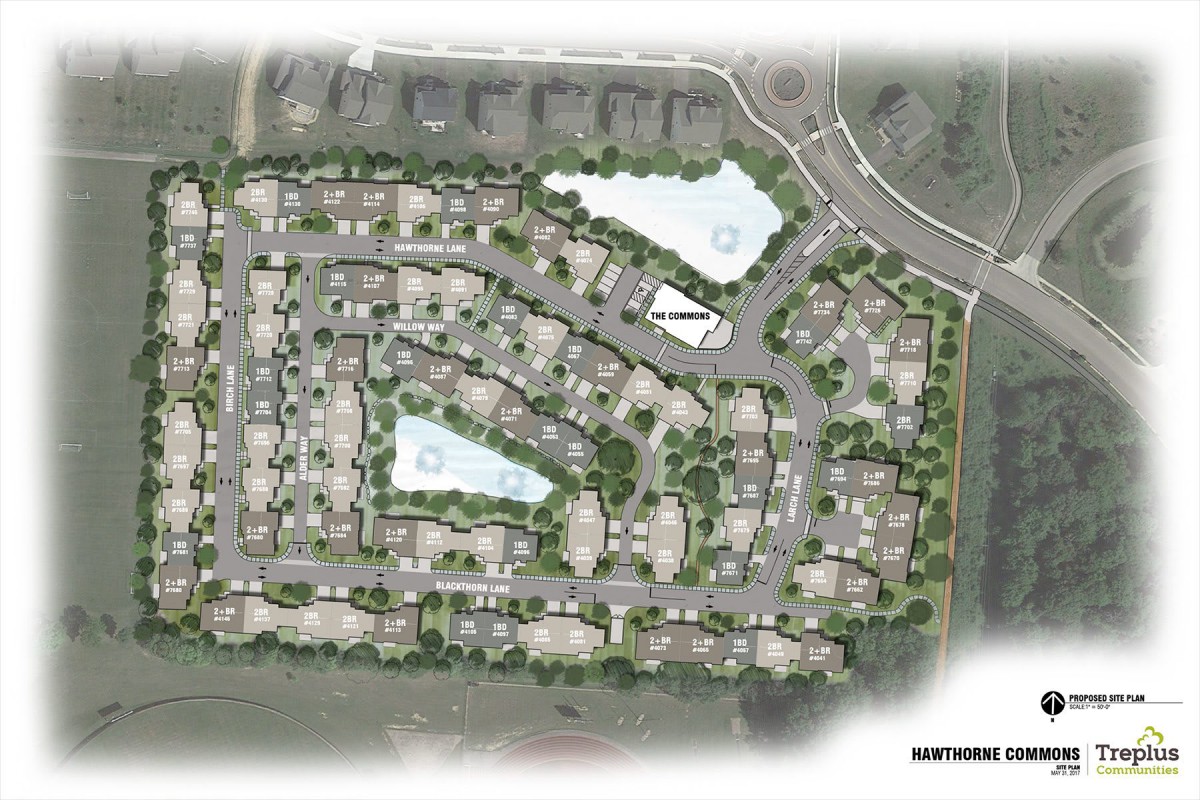 A detailed site plan of a residential housing development featuring roads, buildings, and landscaped areas.