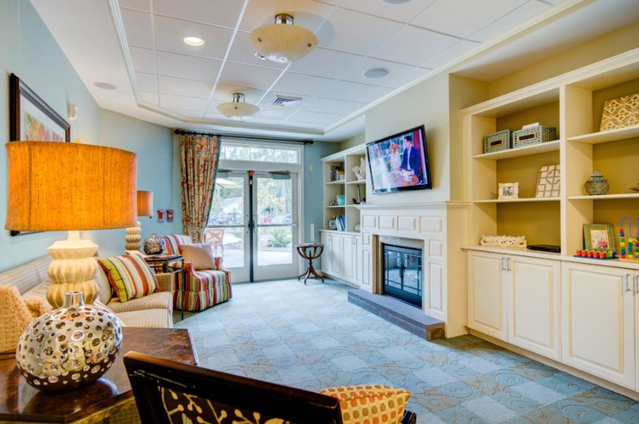 A cozy living room with a fireplace, television, and comfortable seating.