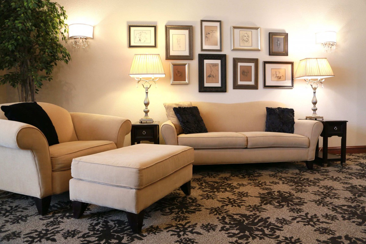 A cozy living room with stylish furniture and wall art.