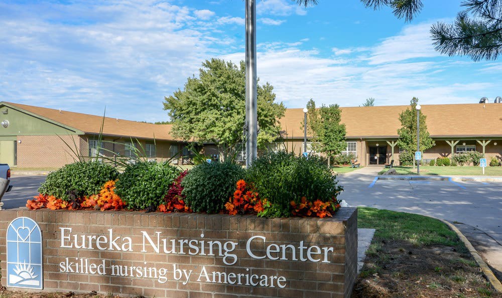 Front view of Eureka Nursing Center with Americare signage and landscaping.