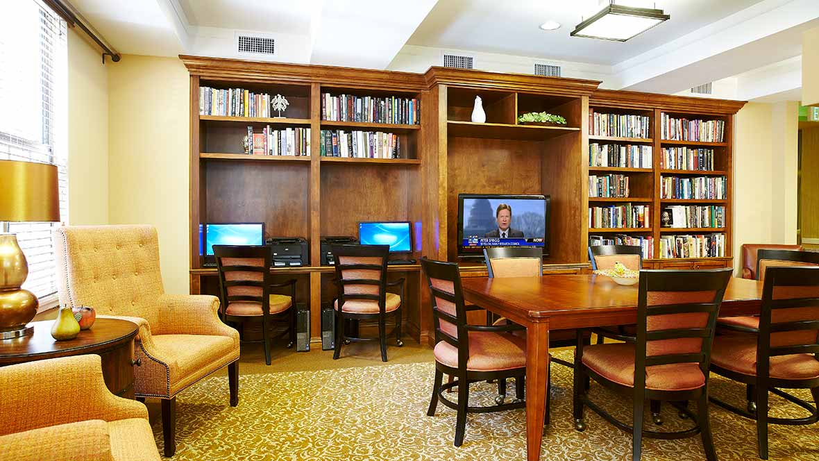 Cozy library with computers and bookshelves.