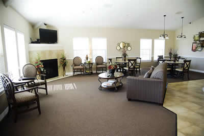 A spacious living room with a fireplace, comfortable seating, and a dining area.