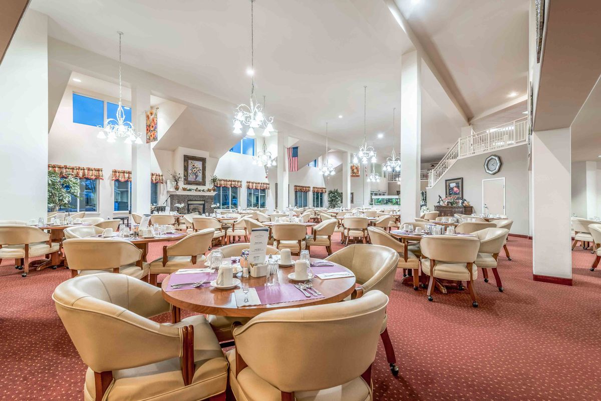 An elegant restaurant interior with neatly arranged tables and chairs, ready for guests.
