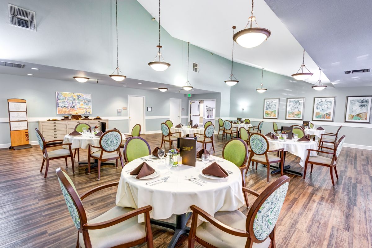 Elegantly decorated restaurant dining area with neatly set tables and chairs.