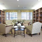 A cozy library with comfortable seating and bookshelves lining the walls.