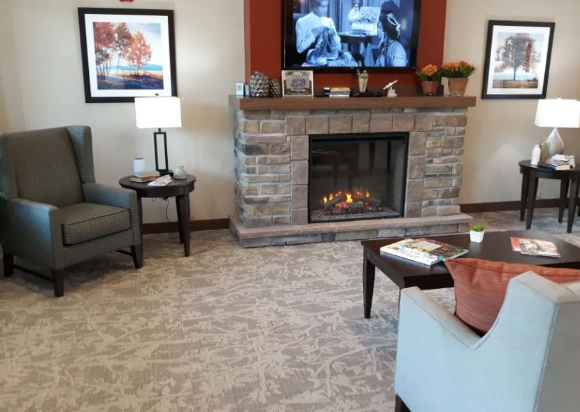 A cozy living room with a fireplace, TV, and comfortable seating.