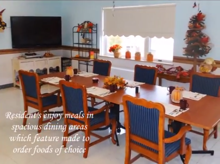 A cozy dining area designed for enjoying meals together, featuring a table set with place settings and warm decor.