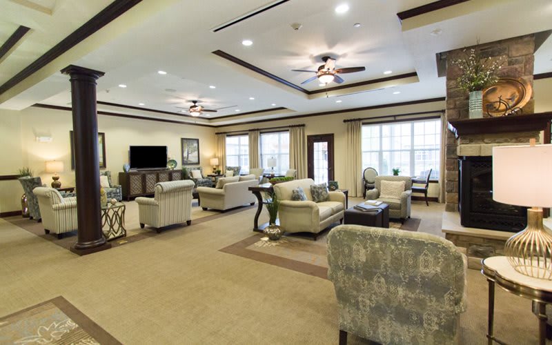 A spacious and elegantly designed living room with comfortable seating and ample natural light.