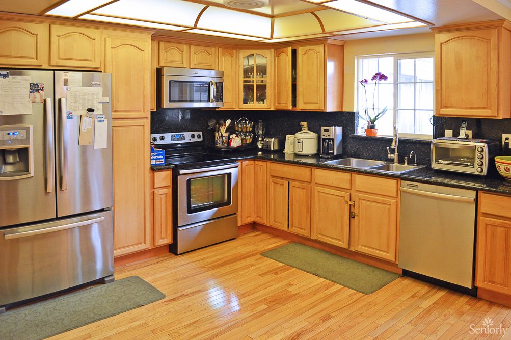 Modern kitchen with wooden cabinets and stainless steel appliances.