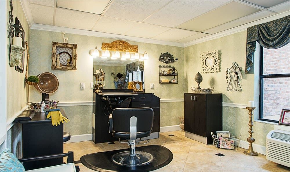 A cozy hair salon with a barber chair and well-lit styling station.