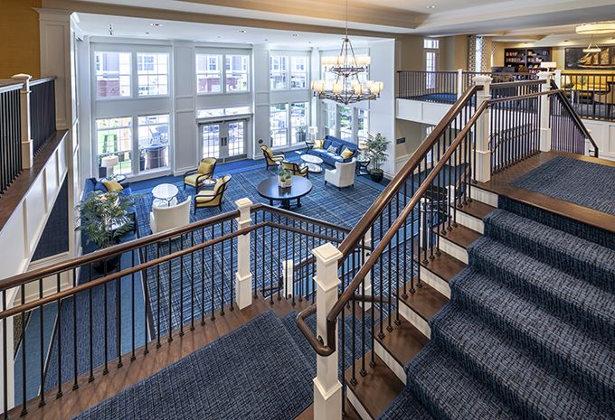 Spacious hotel lobby with elegant seating and a large chandelier.
