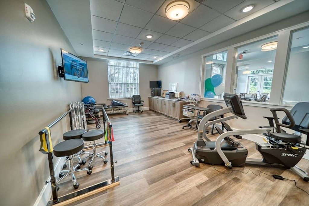 A well-equipped rehabilitation and physical therapy room with various exercise machines.