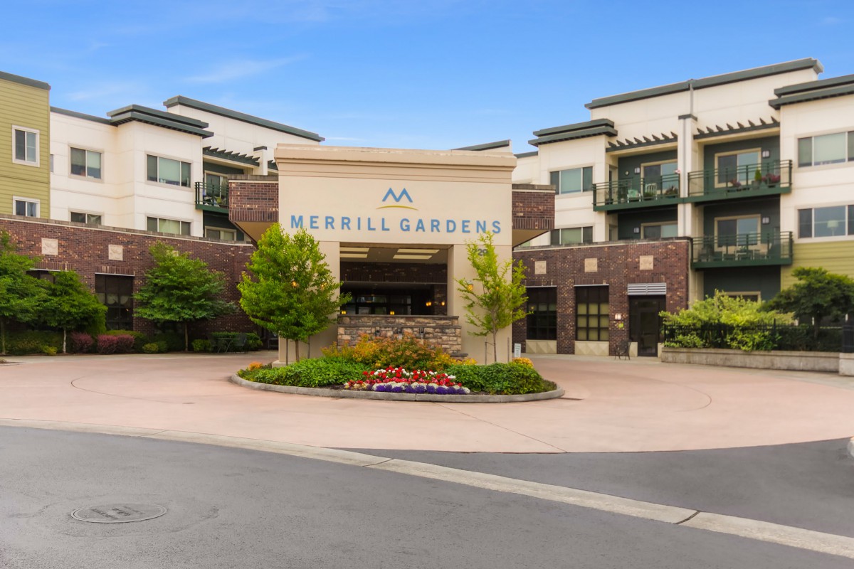 Entrance of a modern building with landscaped surroundings.