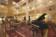 Elegant hotel lobby with a grand piano and luxurious decor.