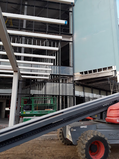 A view of an ongoing construction site showcasing the framework and interior structure of a modern building.