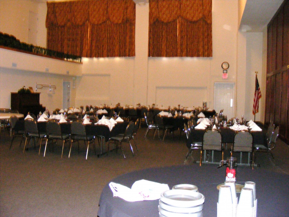 A spacious banquet hall with tables and chairs arranged for an event.